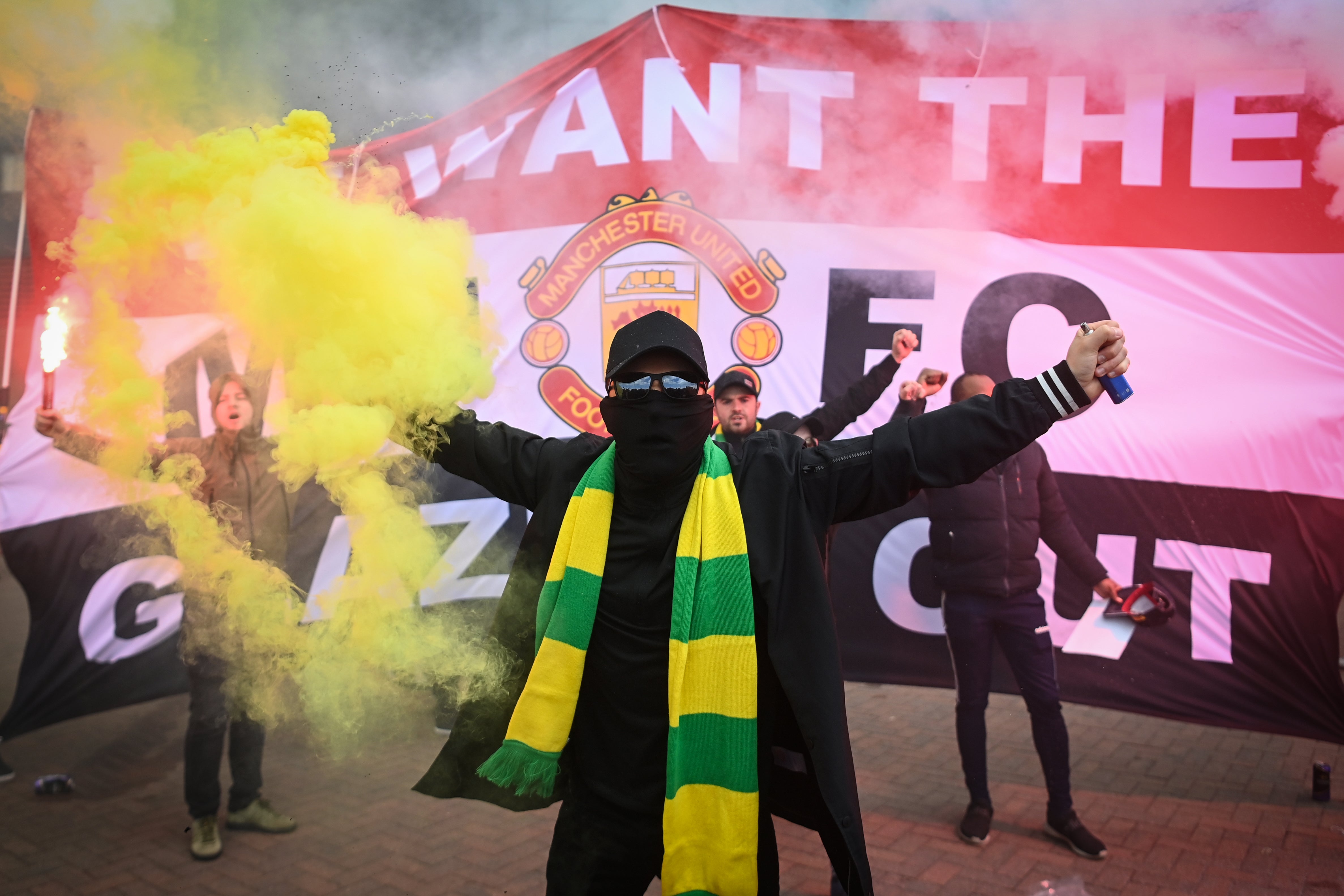 Fans are seen protesting Manchester United’s Glazer ownership outside Old Trafford