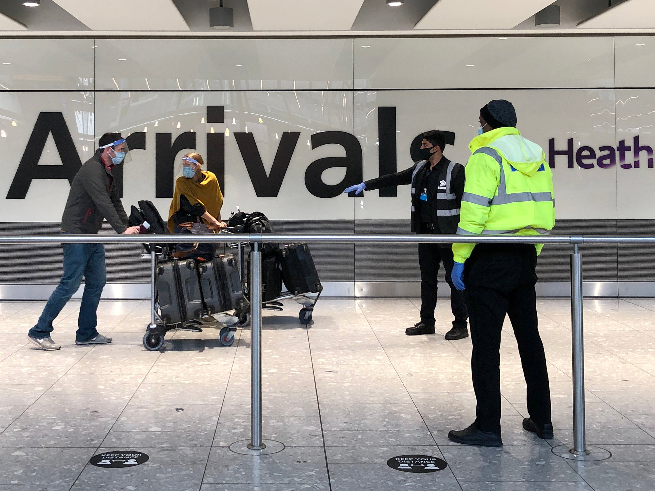 Passengers arriving at Heathrow are directed towards coaches bound for quarantine hotels