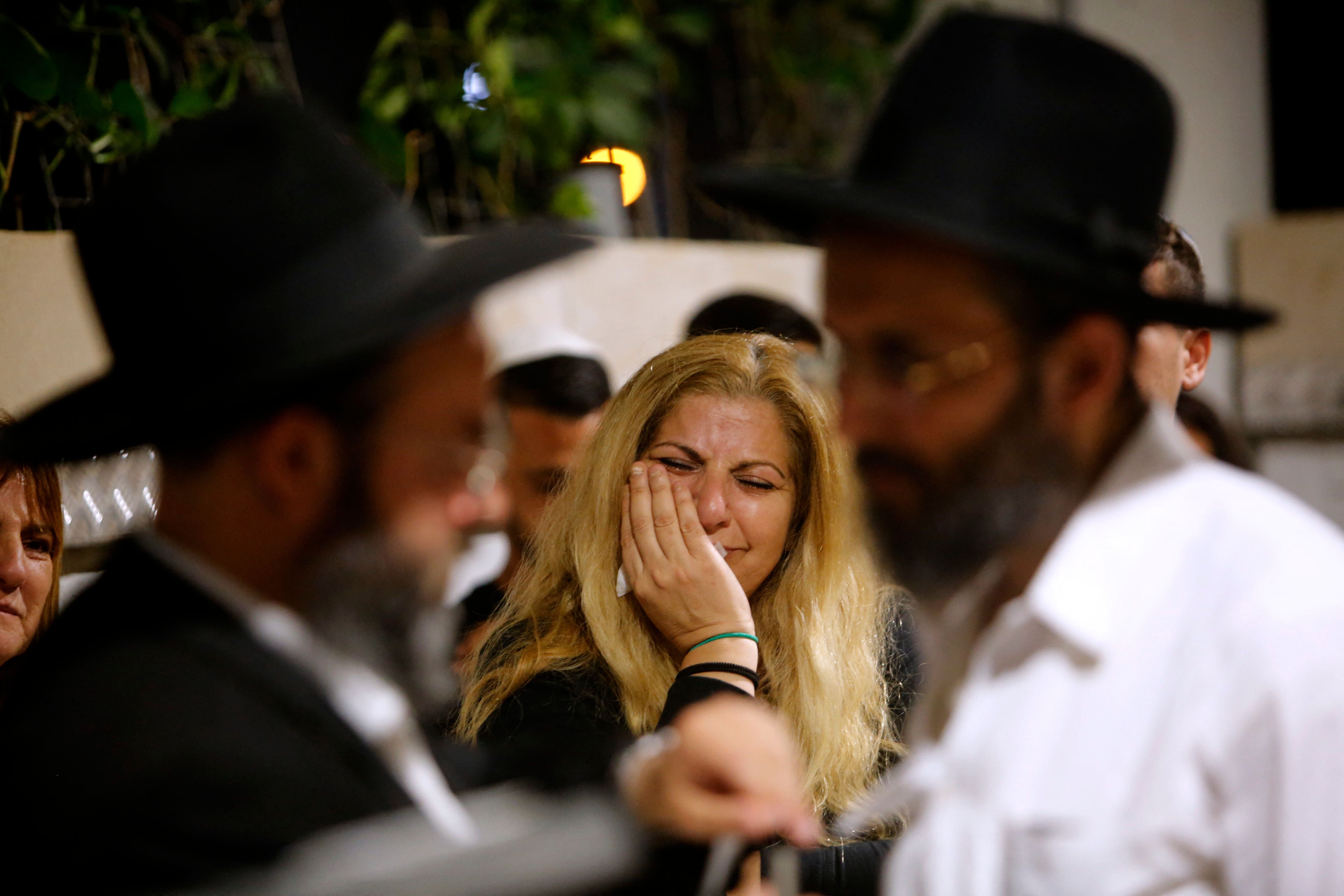 Mourners react during the funeral of Lea Yom Tov, an Israeli woman killed by a rocket attack from the Gaza Stip, in the central city of Rishon LeZion