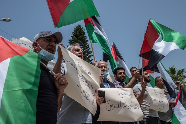 <p>Palestinians protest in Gaza following Israeli evictions in Jerusalem.</p>
