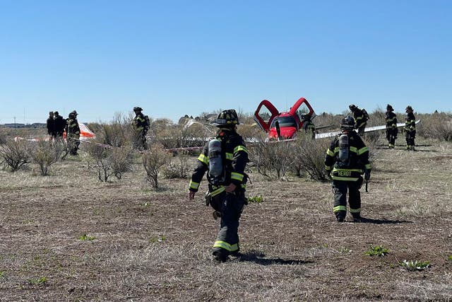 <p>In this photo provided by South Metro Fire Rescue, emergency personnel work at the scene where a single engine plane landed after a mid-air collision near Denver, Wednesday, 12 May 2021. Federal officials say two airplanes collided but that there are no injuries</p>