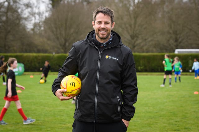 Jamie Redknapp on a pitch with a football under his arm (Matt Cressick /PA)