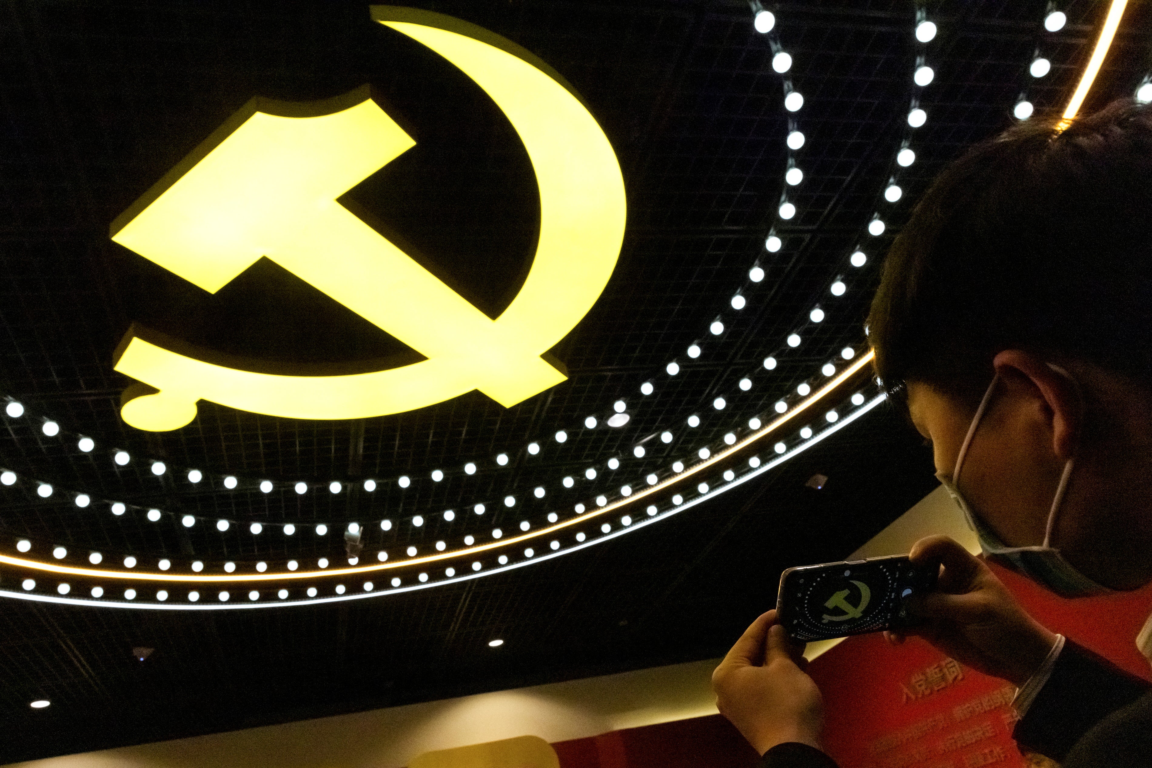 File image: A man takes a picture of the emblem of Chinese Communist Party (CCP) at an exhibition marking the party's 100th founding anniversary in Beijing, China