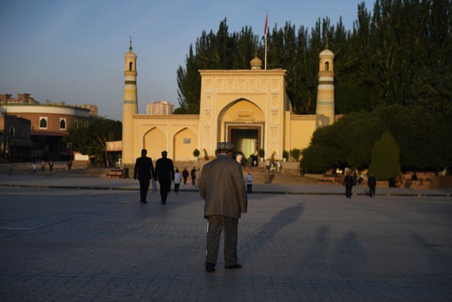 <p>A Uighur walks towards the Id Kah mosque in China’s western Xinjiang region</p>