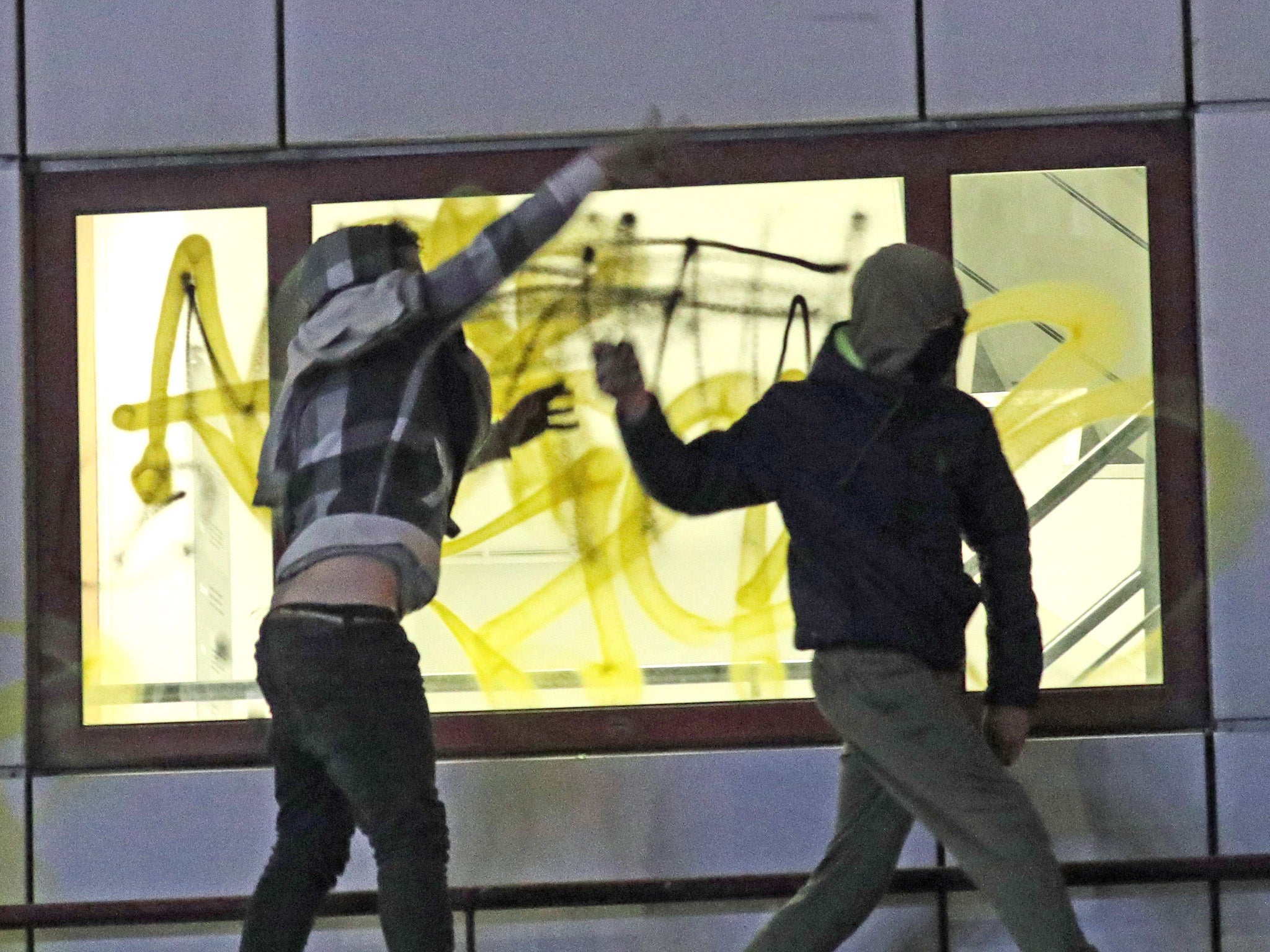 Rioters hurl objects from a roof of Bridewell Police Station on 21 March