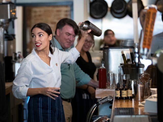 <p>U.S. Rep. Alexandria Ocasio-Cortez (D-NY) shakes a margarita behind the bar at the Queensboro Restaurant, May 31, 2019 in the Queens borough of New York City</p>