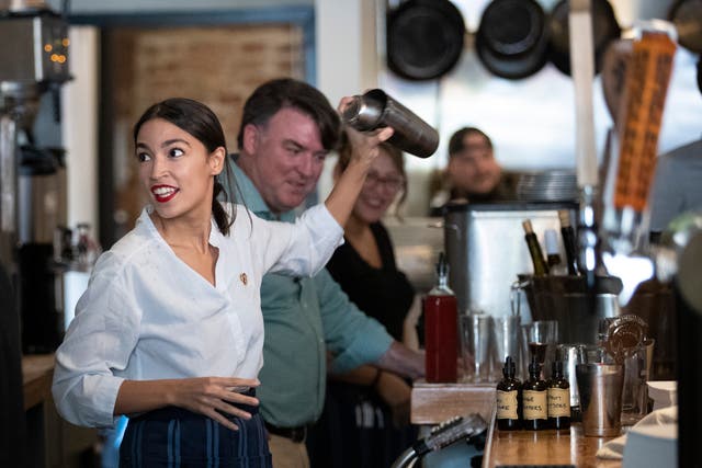 <p>U.S. Rep. Alexandria Ocasio-Cortez (D-NY) shakes a margarita behind the bar at the Queensboro Restaurant, May 31, 2019 in the Queens borough of New York City</p>