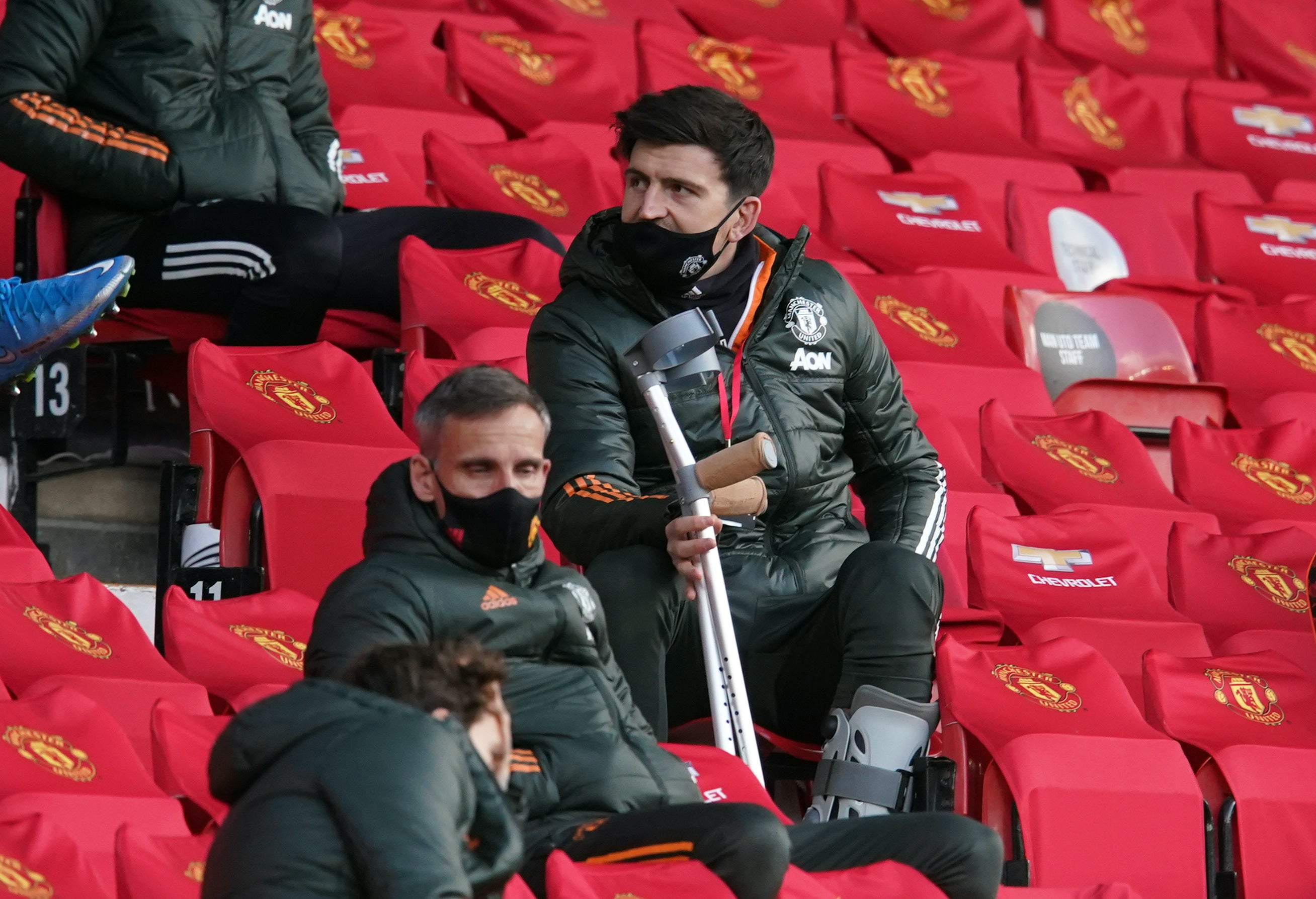 Harry Maguire watches on from the stands at Old Trafford