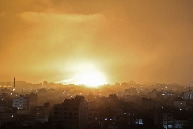 An explosion lights the sky following an Israeli air strike on Beit Lahia in the northern Gaza Strip