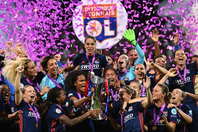 Last season’s Champions League winners Lyon celebrate with the trophy