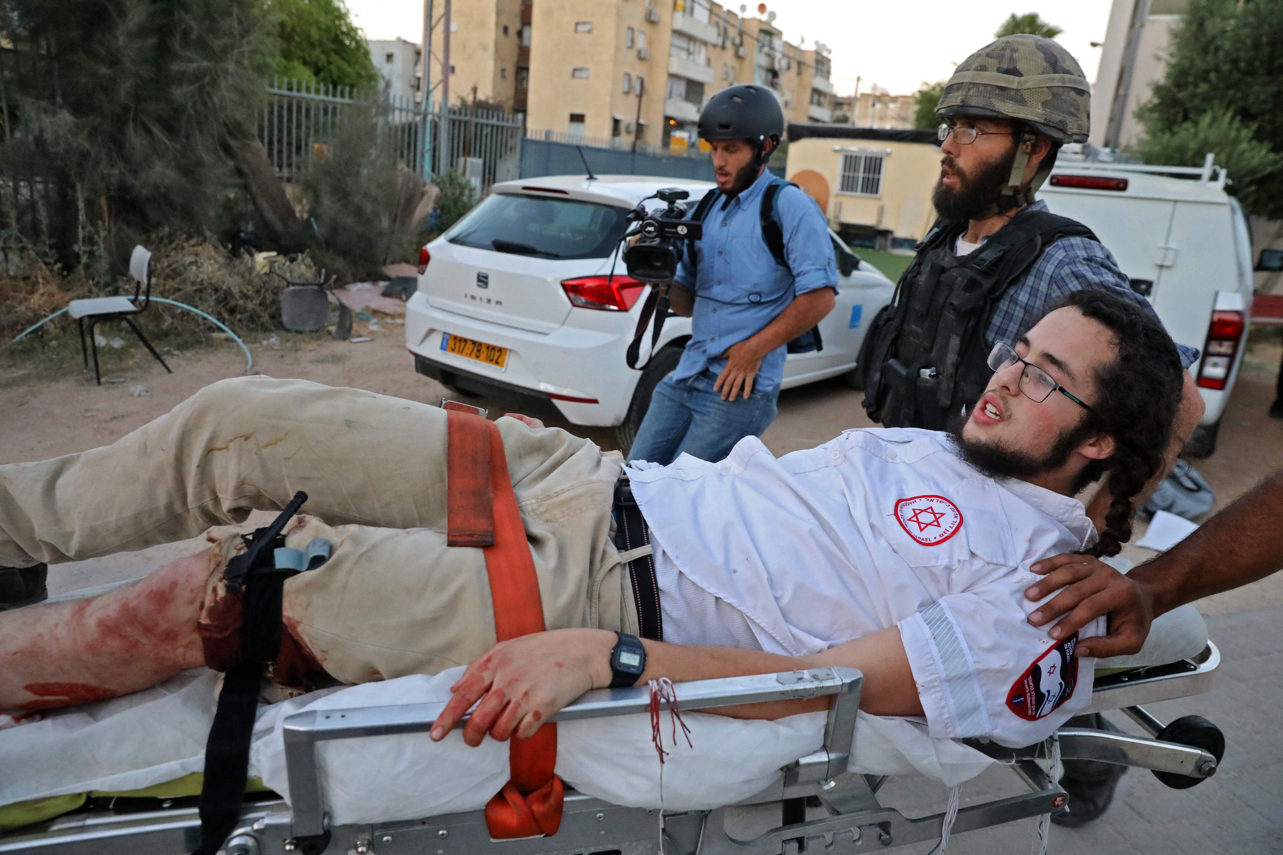 An Israeli far-right extremist is taken away on a stretcher after being wounded during clashes with Arab-Israelis in Lod