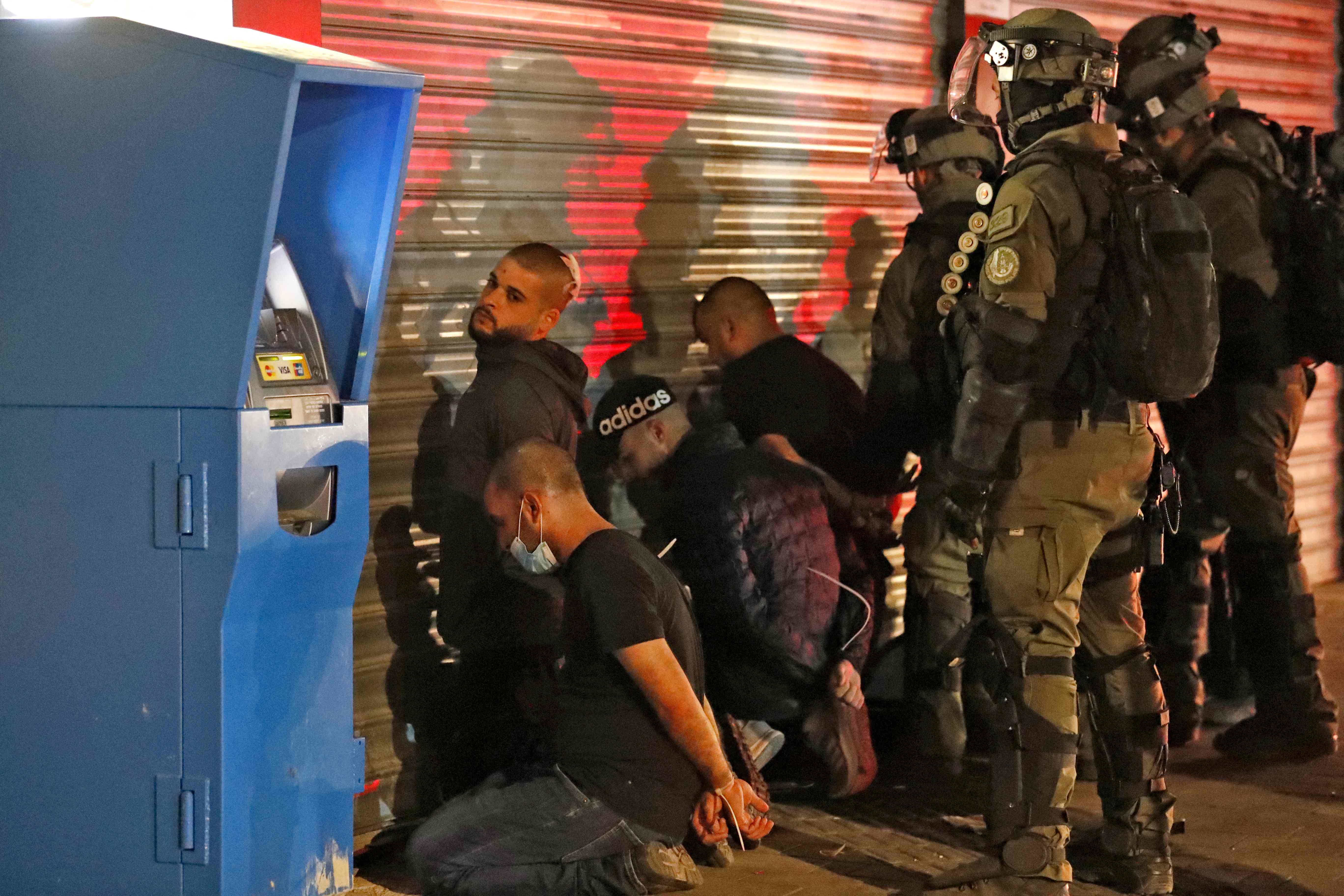 Israeli forces detain a group of Arab-Israelis in Lod