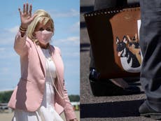 Jill Biden wears a Valentino purse featuring portraits of German shepherds Major and Champ 