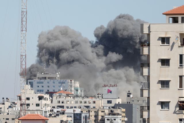 <p>Smoke rises after Israeli forces destroyed building in Gaza City where Al-Jazeera and Associated Press had their offices, on Saturday (15 May)</p>