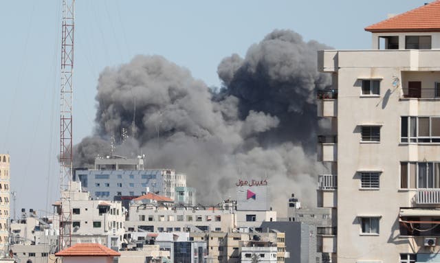 <p>Smoke rises after Israeli forces destroyed building in Gaza City where Al-Jazeera and Associated Press had their offices, on Saturday (15 May)</p>