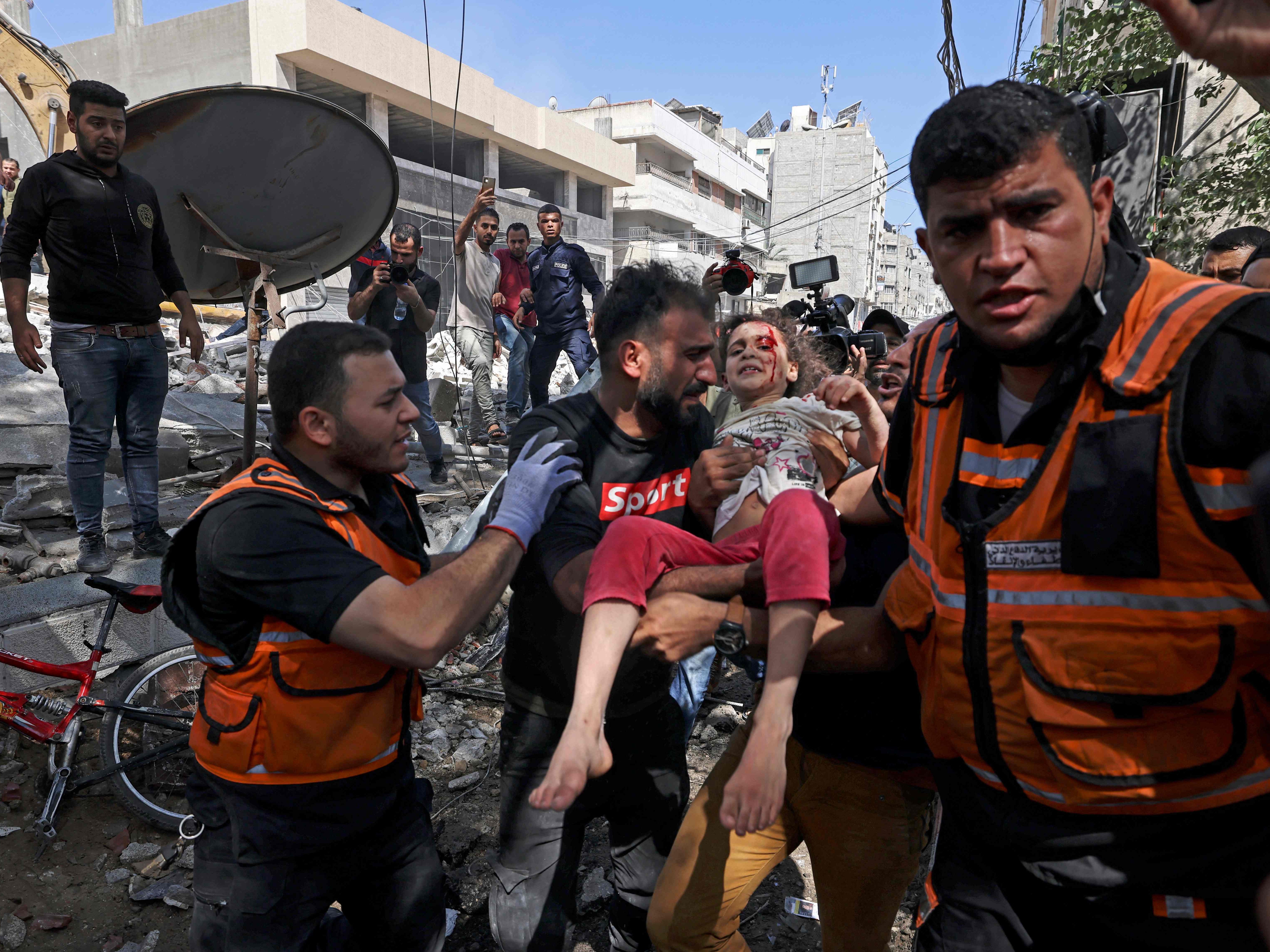 Paramedics evacuate a child in Gaza City