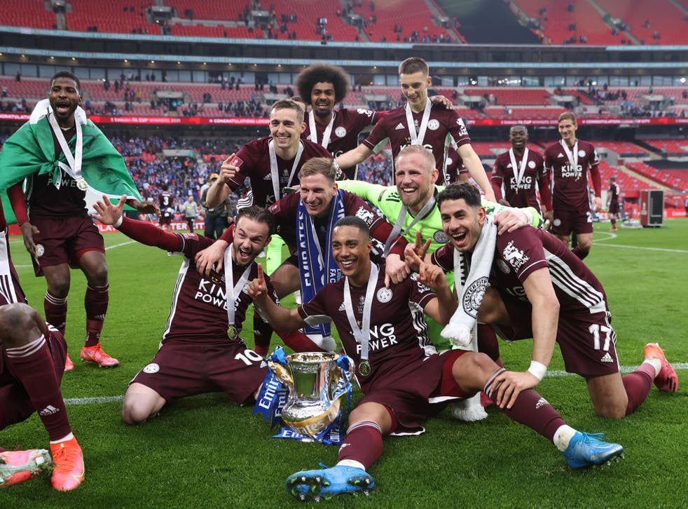 Leicester City players celebrate with the FA Cup trophy