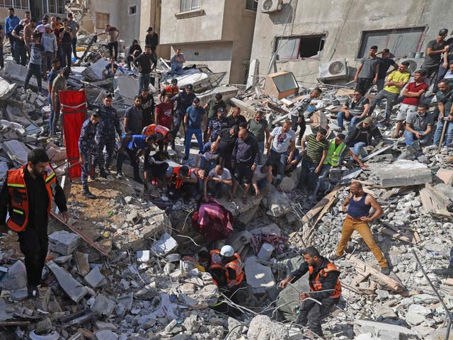 Paramédicos palestinos buscan sobrevivientes bajo los escombros de un edificio destruido en la ciudad de Gaza