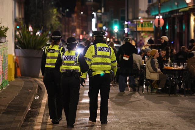 <p>Police officers patrol the streets in Manchester’s Northern Quarter in April</p>