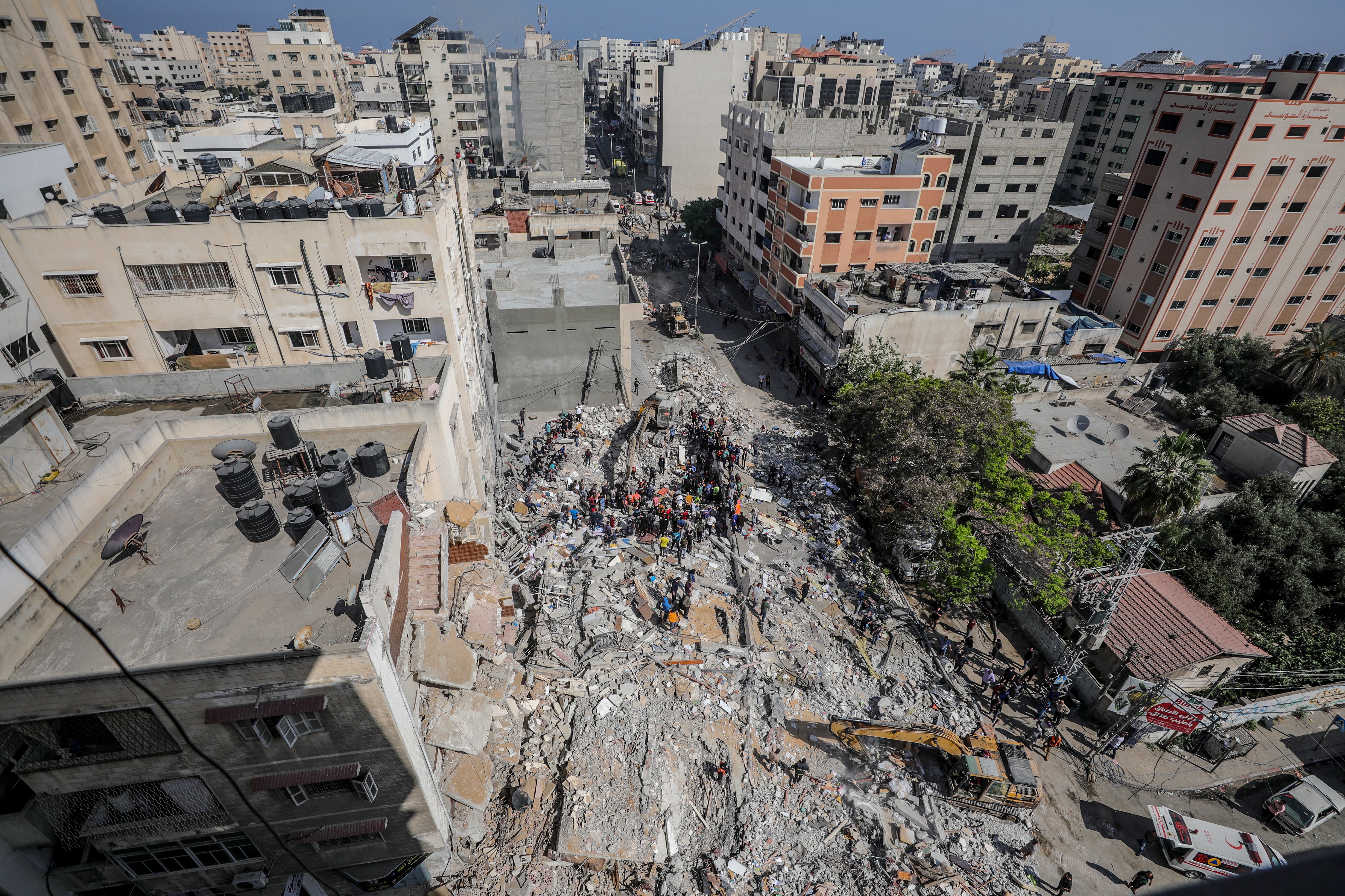 Palestinian civil defence search for survivors in the rubble of a destroyed house after an Israeli air strike in Gaza City