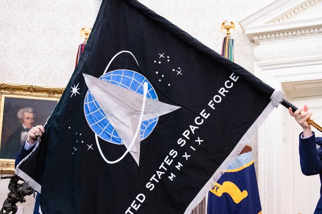 <p>A lieutenant colonel from the newly formed Space Force, who flag is pictured being unveiled in the White House in 2020, has been reportedly removed from his post for criticising the US Military as “Marxist”</p>