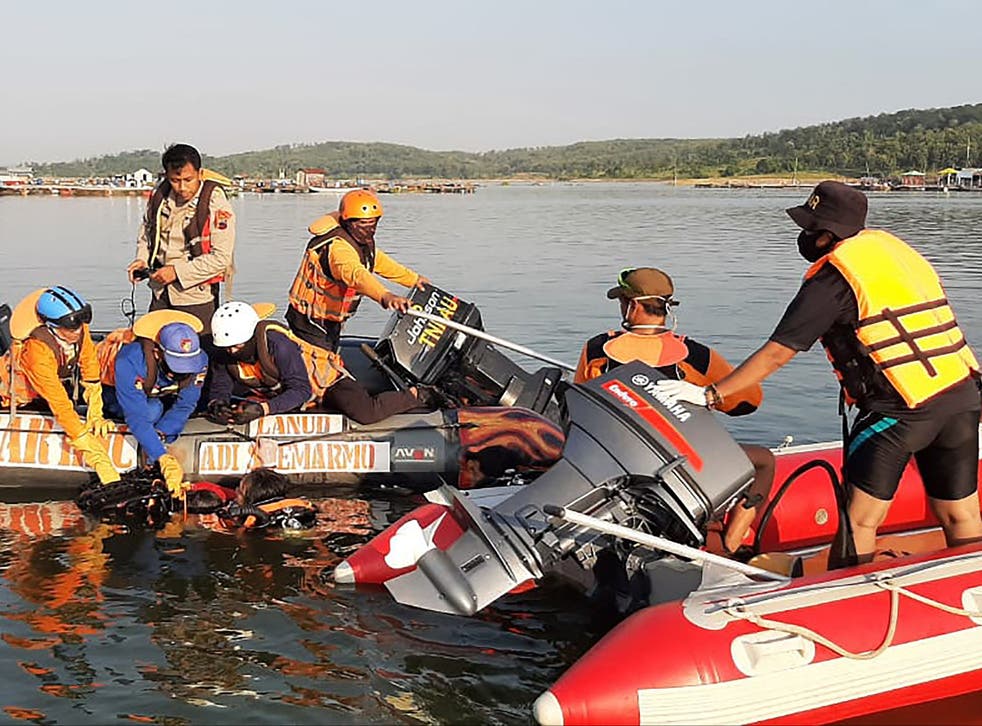 Rescuers searching for victims after a boat carrying 20 holiday-makers capsized in Indonesia