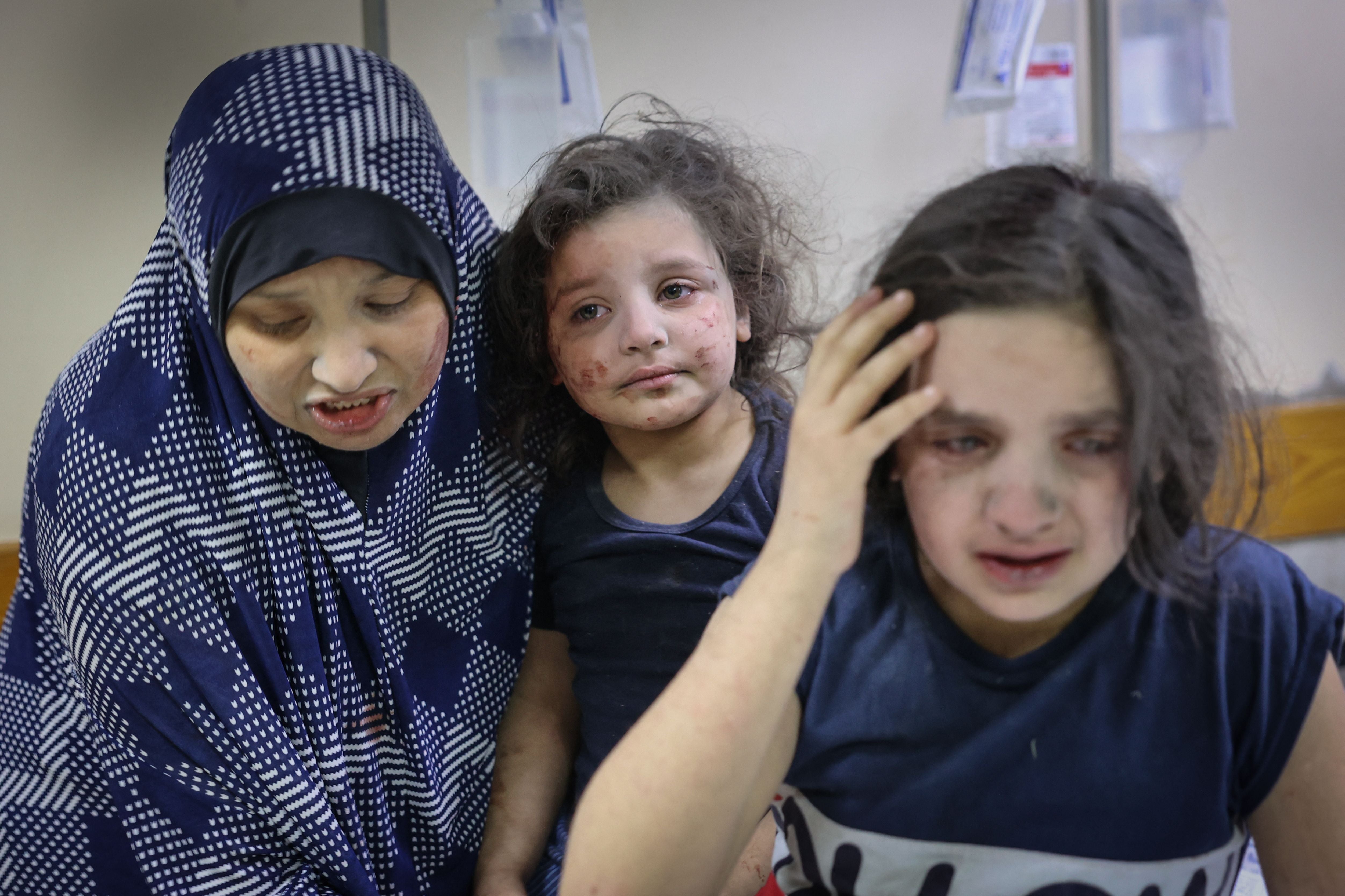 A Palestinian family arrives at Shifa hospital after intensive bombardments on Gaza