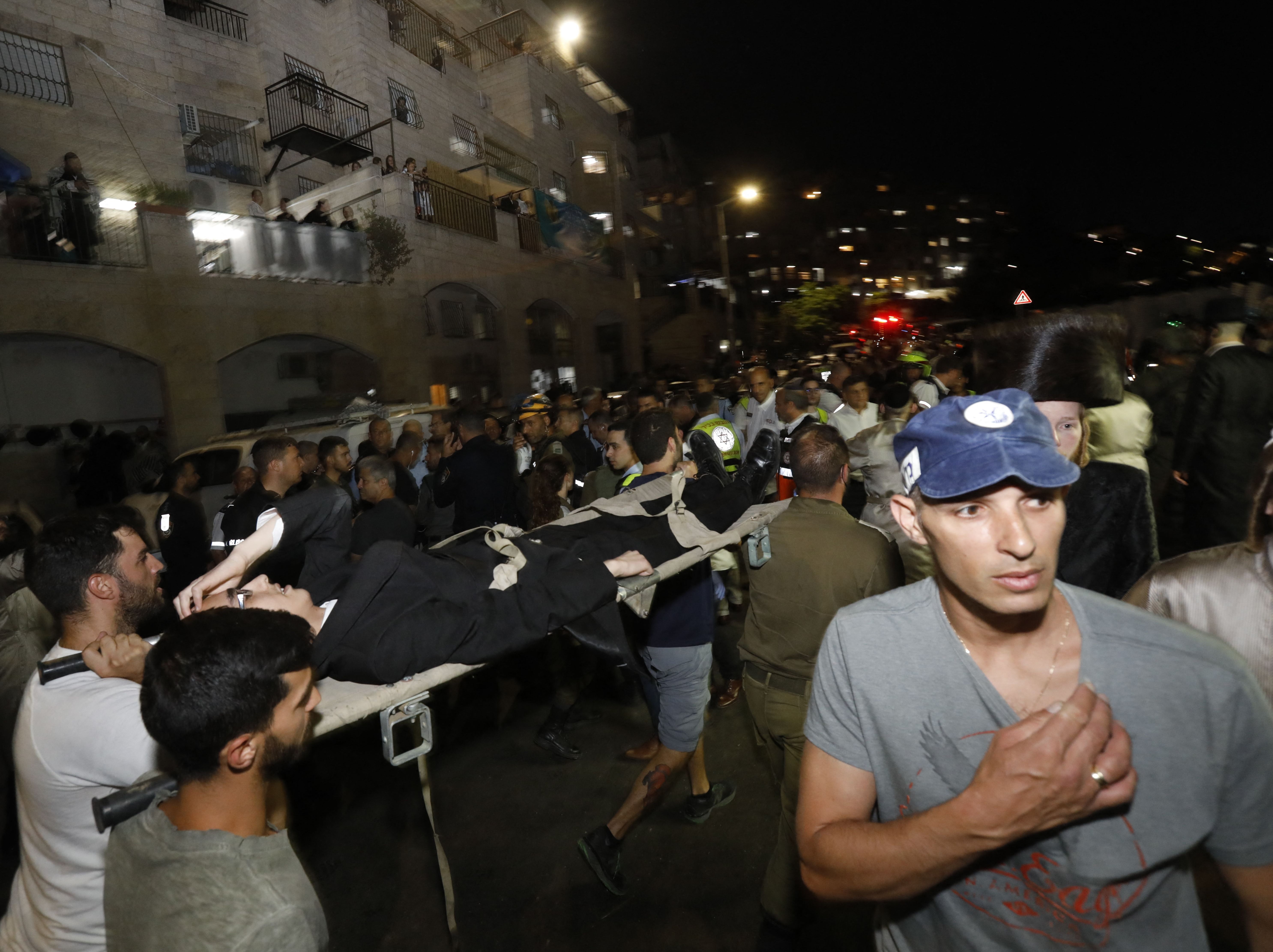 Medics and members of the Israeli security forces evacuate an injured child after the collapse