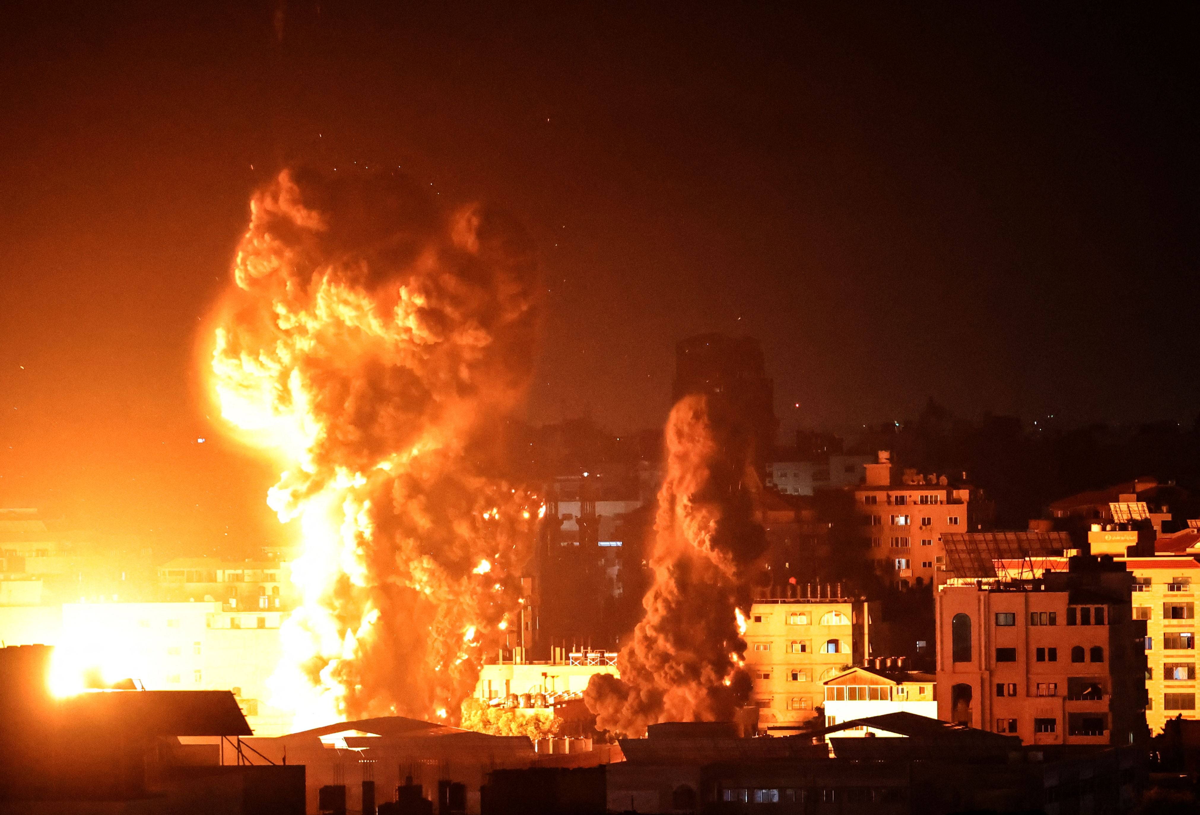 Fire and smoke rise above buildings in Gaza City as Israeli warplanes target the Palestinian enclave, early on 17 May, 2021.