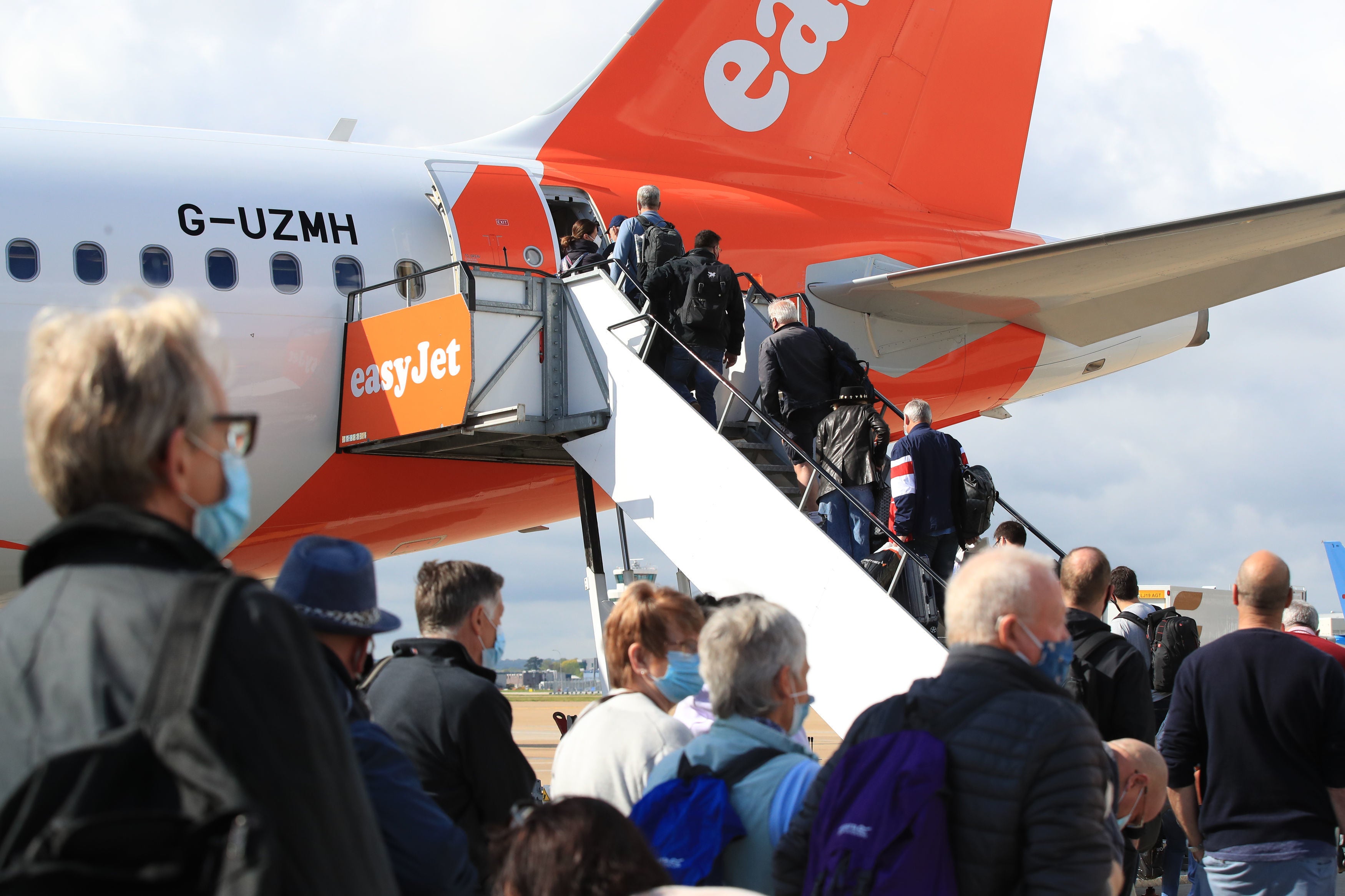 Passengers prepare to board an easyJet flight to Faro, Portugal, at Gatwick