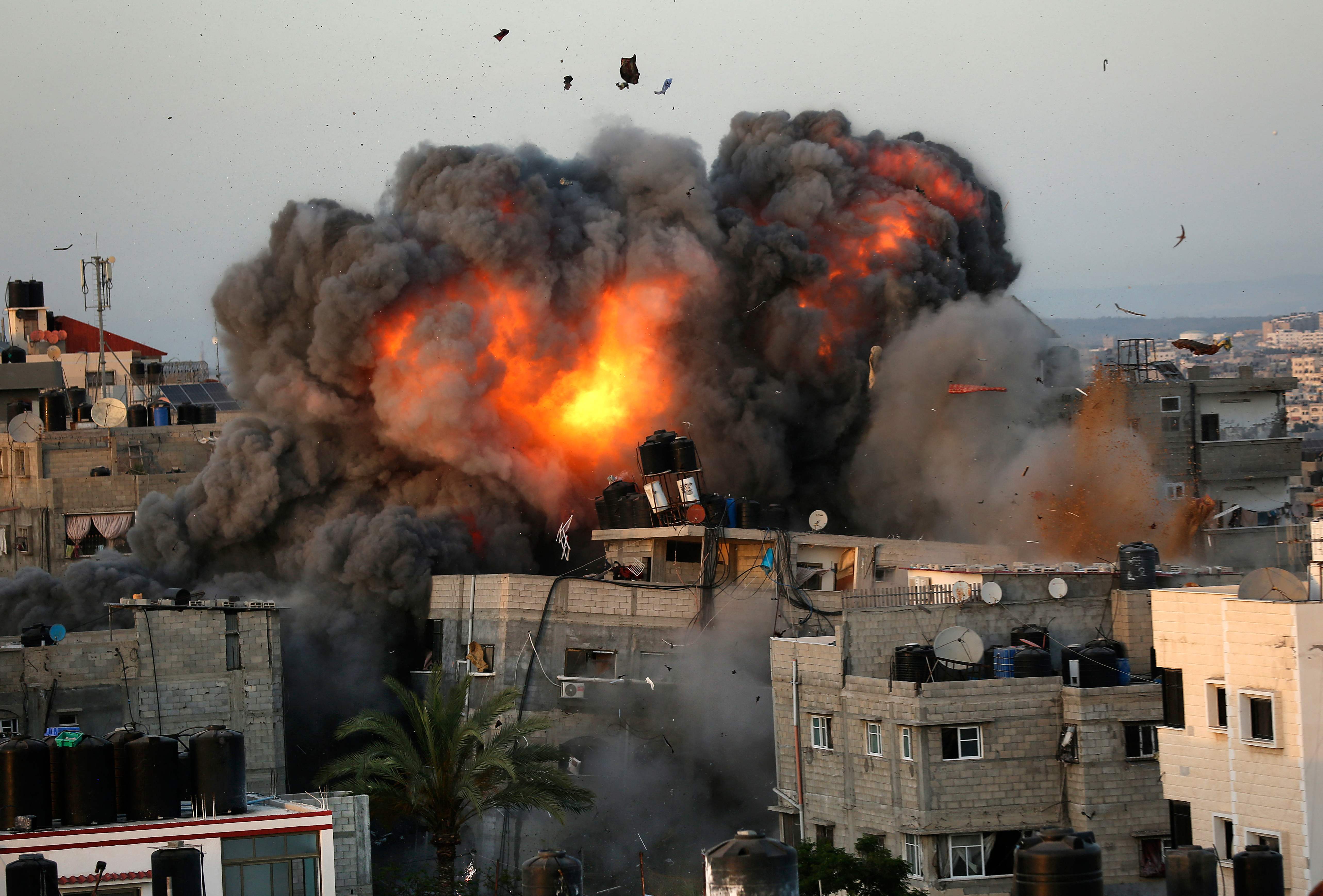 A ball of fire erupts from a building in Gaza City’s Rimal residential district