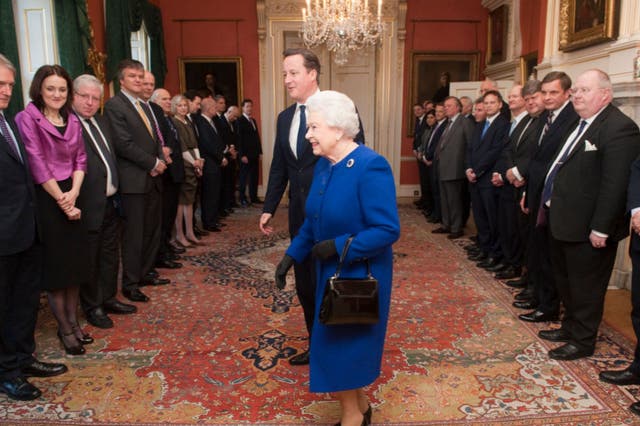Queen Elizabeth II arrives with British Prime Minister David Cameron to meet members of the cabinet at Number 10 Downing Street as she attends the Government’s weekly Cabinet meeting on December 2012 in London
