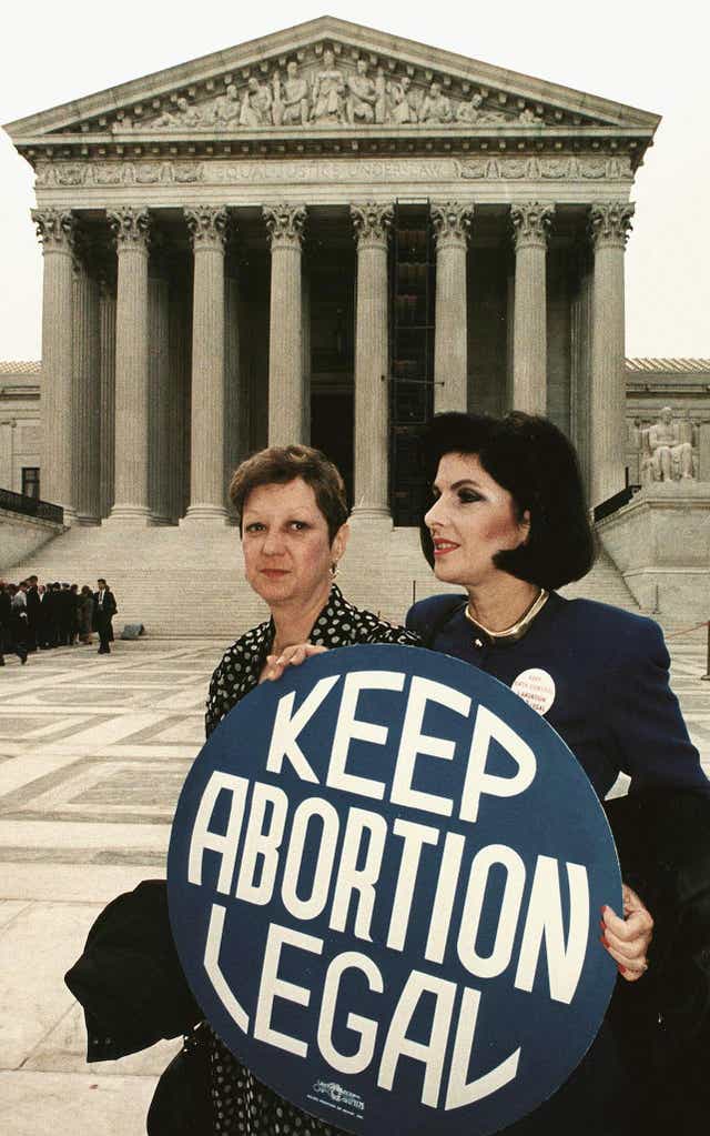 <p>This April 26, 1989 file photo shows Norma McCorvey (L), known as "Jane Roe" in the 1973 landmark Roe vs Wade ruling that expanded abortion rights in the US, holding a pro-choice sign with attorney Gloria Allred (R) in front of the US Supreme Court building prior to attending arguments on an abortion case in Washington, DC. </p>