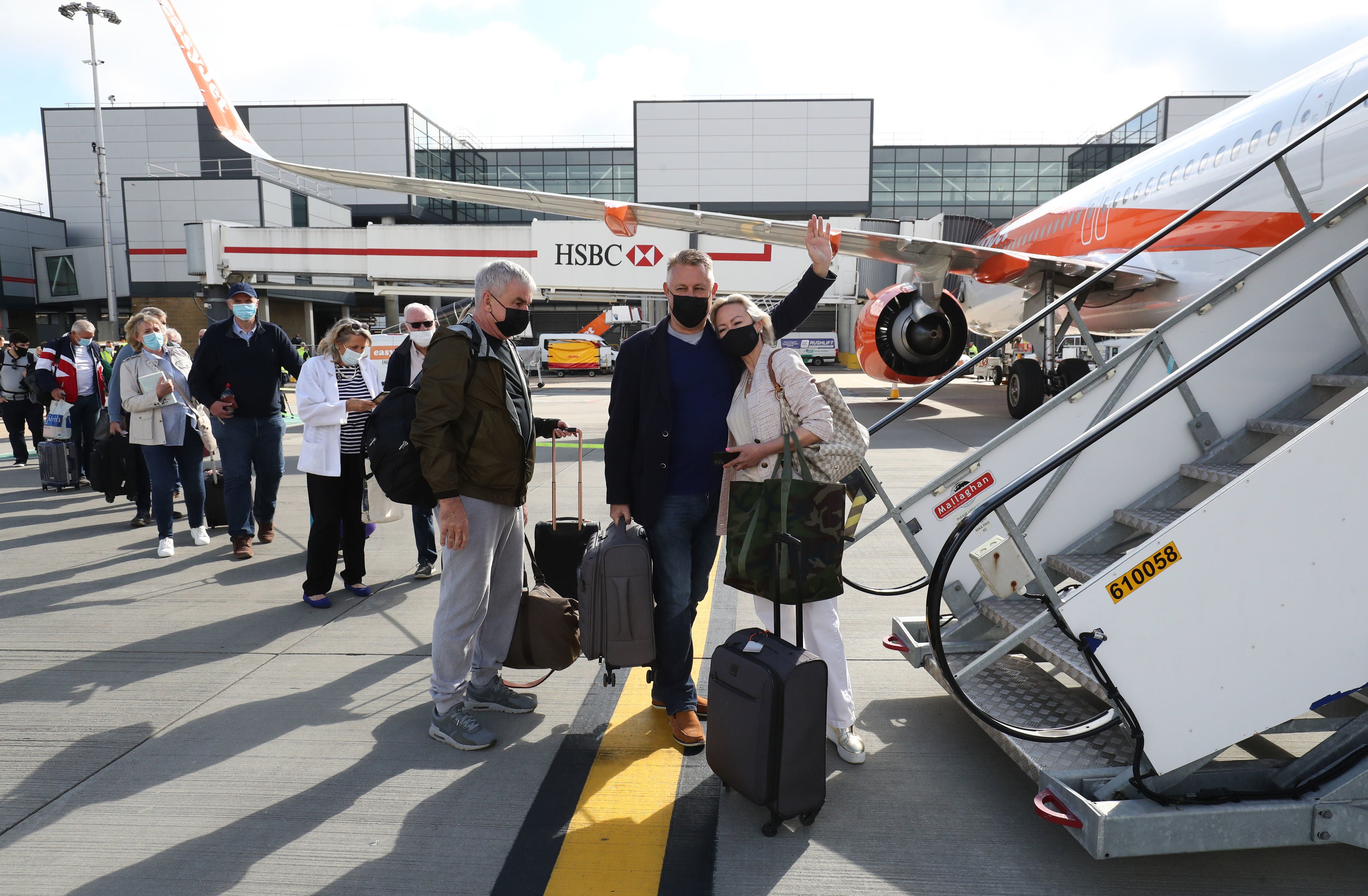 Passengers prepare to board an easyJet flight to Faro, Portugal, at Gatwick Airport