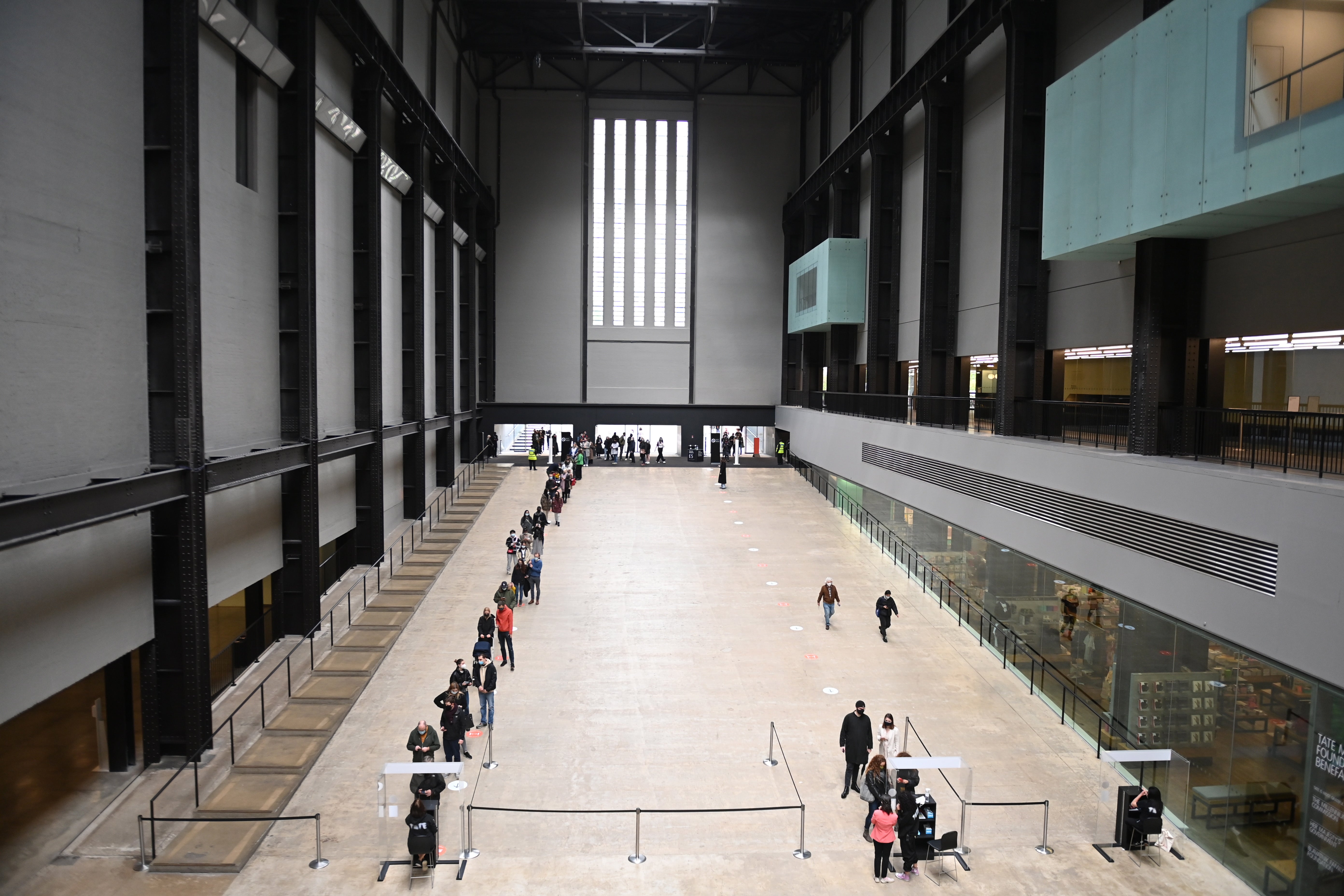 Visitors queue to enter the Tate Modern art gallery in London