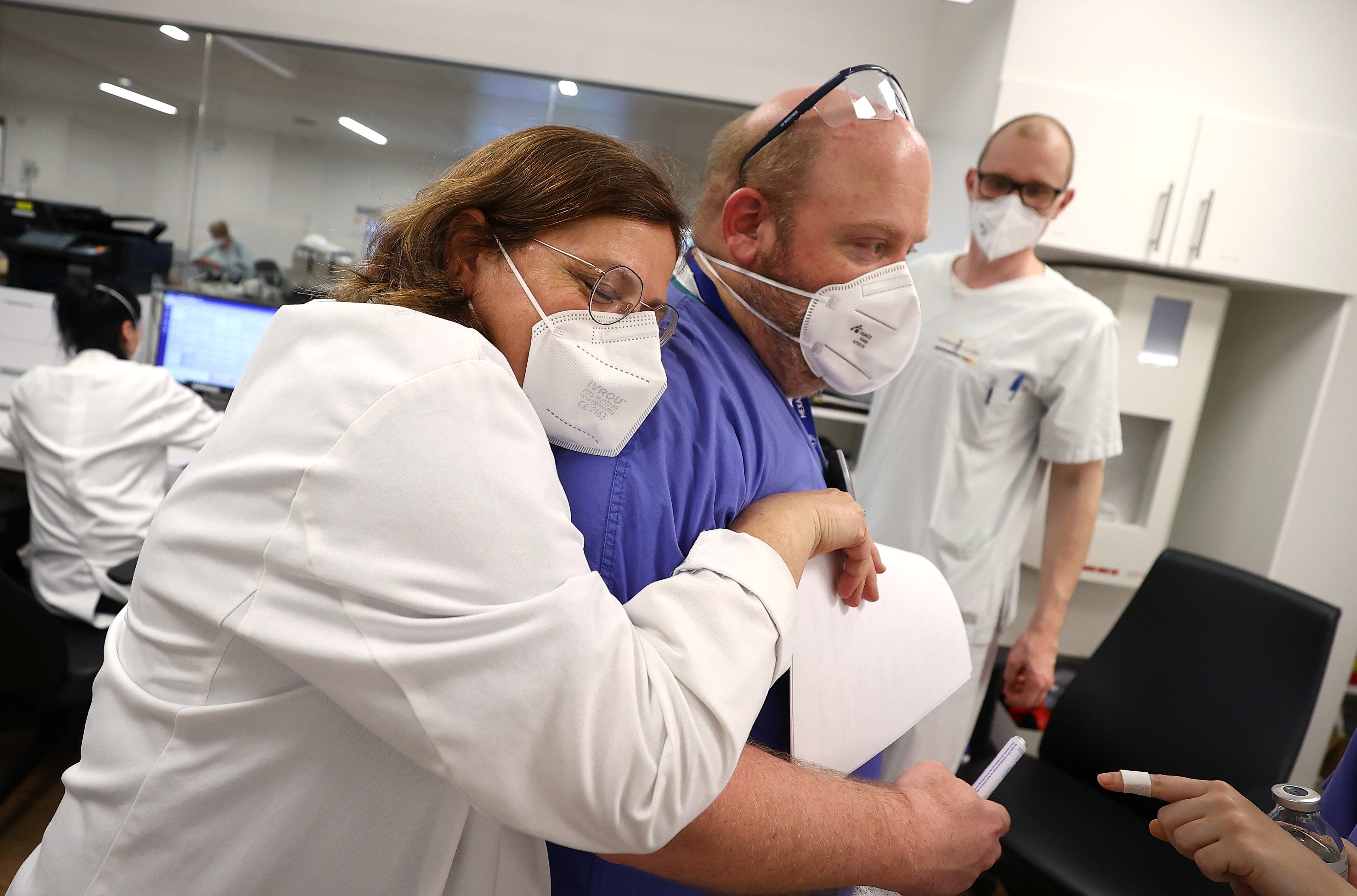 Doctor Christine Hidas (L), head of the emergency department, embraces a colleague during a busy shift as the spread of the coronavirus disease (COVID-19) continues, at a clinic in Darmstadt, Germany