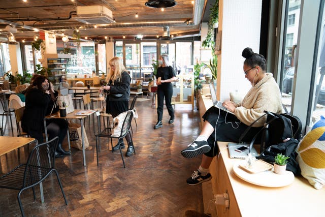 <p>Members of the public sit in a cafe, as pubs, cafes and restaurants in England reopen indoors under the latest easing of the coronavirus lockdown</p>