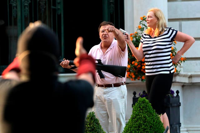 <p>Armed homeowners Mark and Patricia McCloskey confront Black Lives Matter protesters in St Louis on 28 June, 2020</p>