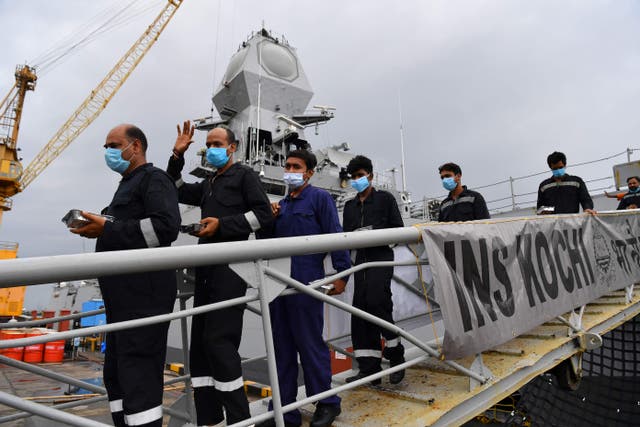 <p>Rescued crew members from the sunken barge P305 disembark after arriving in Mumbai on 19 May 2021</p>