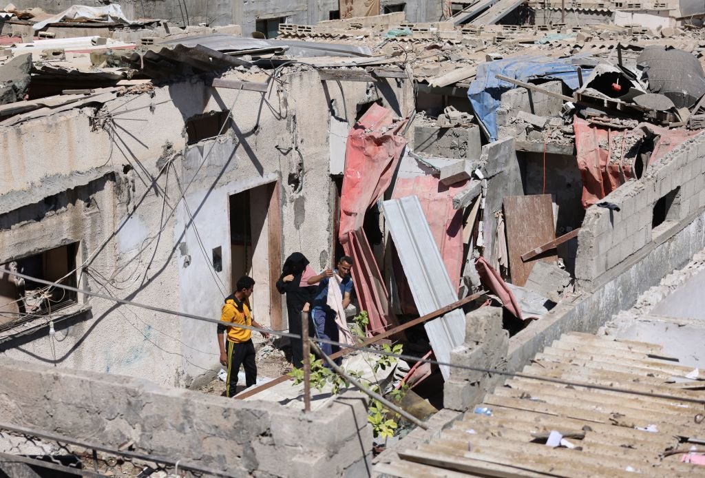 Palestinians check the aftermath of Israeli airstrikes in Rafah in the southern Gaza Strip