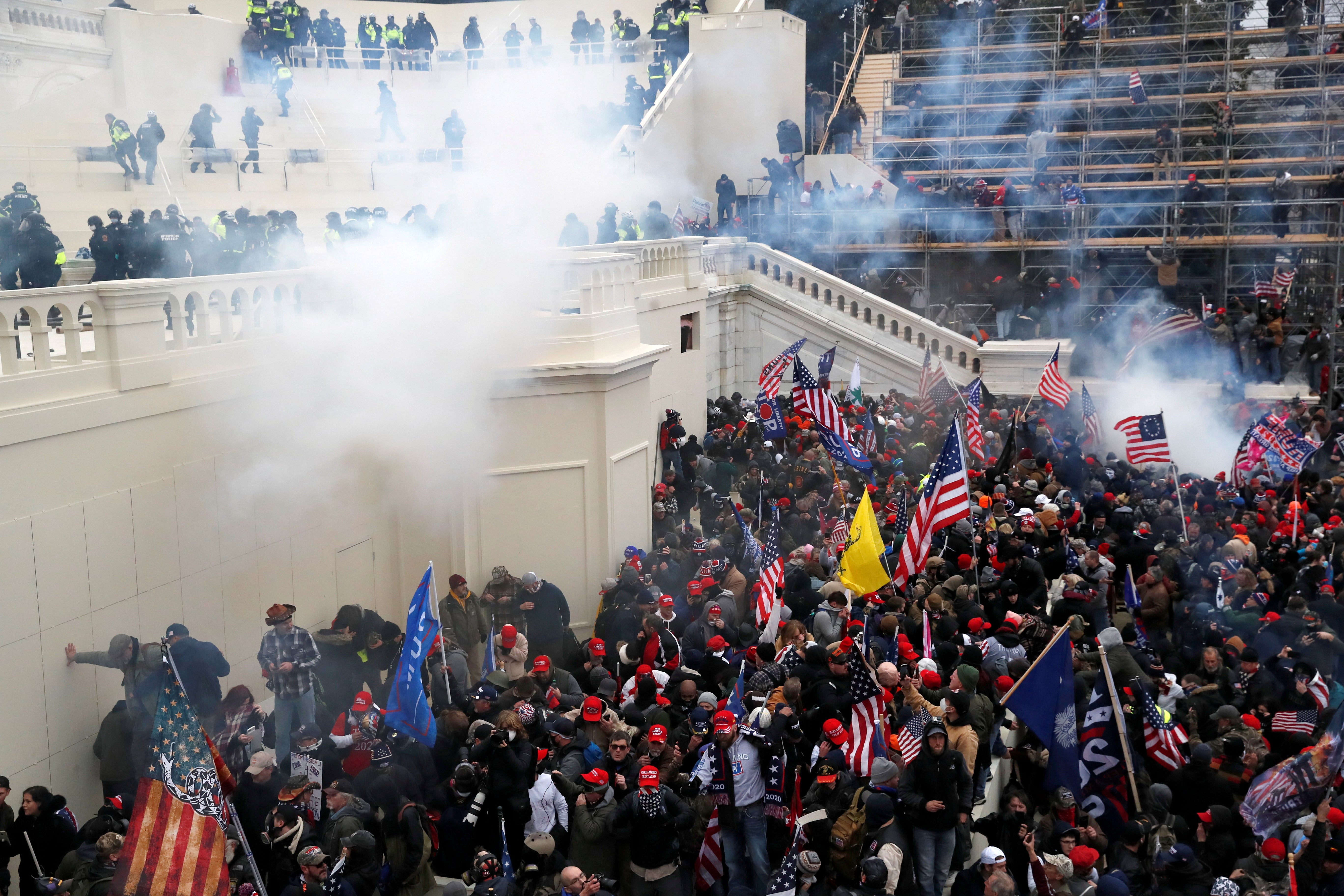 Police release tear gas into a crowd of pro-Trump protesters during clashes at a rally to contest the certification of the 2020 US presidential election results by Congress, at the Capitol Building in Washington, 6 January 2021.