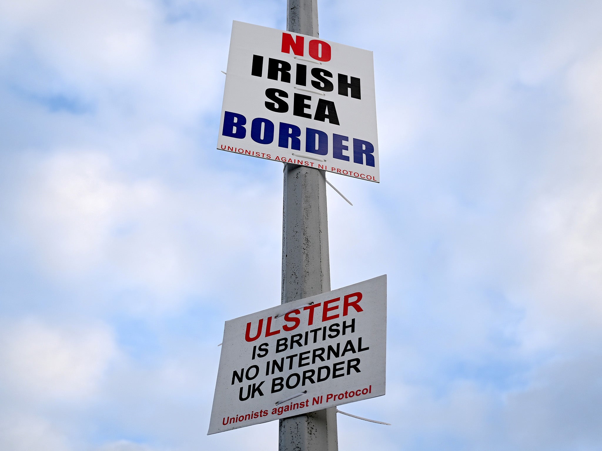 Signs opposed to the Irish Sea border affixed to a lamp post in Port of Larne, Northern Ireland