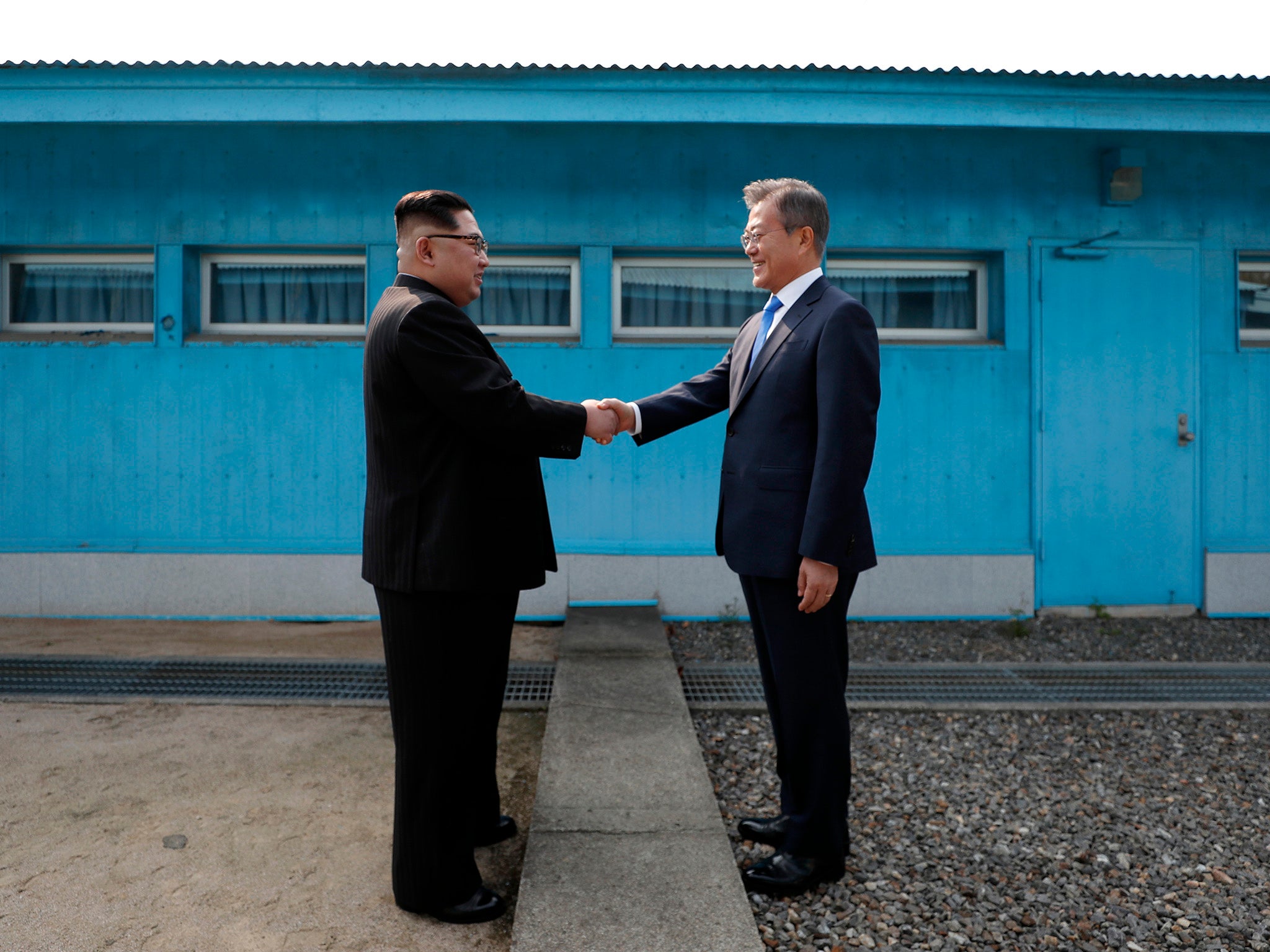 North Korea’s Kim Jong-un shakes hands with South Korea’s Moon Jae-in at the Military Demarcation Line that divides their countries, ahead of their summit at the truce village of Panmunjom in 2018