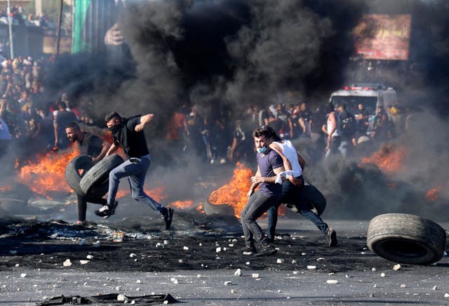 <p>Palestinian protesters confront Israeli troops at the Hawara checkpoint south of Nablus city in the occupied West Bank</p>