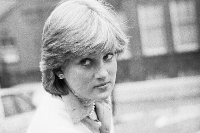 Lady Diana Spencer opens a car door as she holds her coat, London, UK, 13th November 1980.