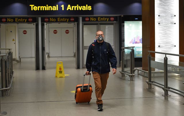 A passenger wearing PPE to prevent the spread of Covid-19, arrives at Terminal 1 of Manchester Airport in northern England, on 8, June, 2020.