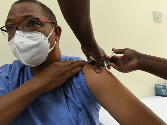 A Kenyan health worker receives a dose of the Oxford/AstraZeneca vaccine at the Kenyatta National Hospital in Nairobi