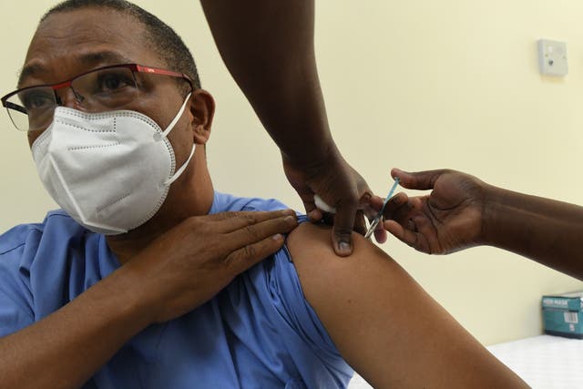 A Kenyan health worker receives a dose of the Oxford/AstraZeneca vaccine at the Kenyatta National Hospital in Nairobi