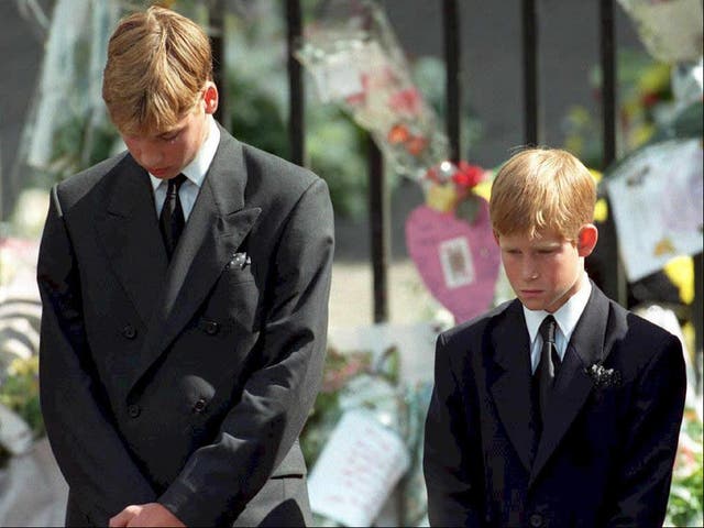 Prince William (left) and Prince Harry, the sons of Diana, Princess of Wales, bow their heads as their mother’s coffin is taken out of Westminster Abbey following her funeral service