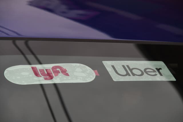 <p>Rideshare drivers demonstrate against rideshare companies Uber and Lyft during a car caravan protest on August 6, 2020 in Los Angeles</p>